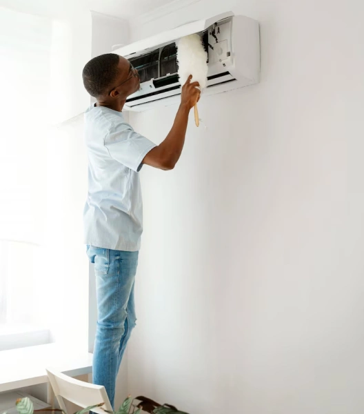 AC worker cleaning inside AC unit